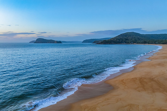 Aerial sunrise at the seaside with light scattered high cloud an