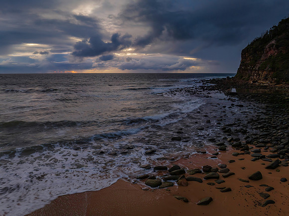 Moody sunrise seascape with rain clouds