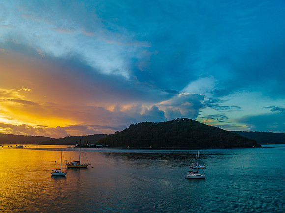 Aerial sunrise waterscape with boats, colour and clouds