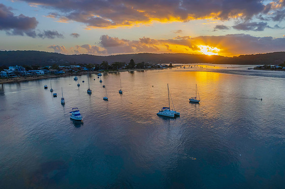 Aerial sunrise waterscape with boats