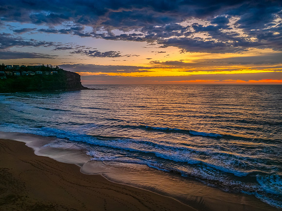 Pretty Sunrise at the seaside with rain clouds