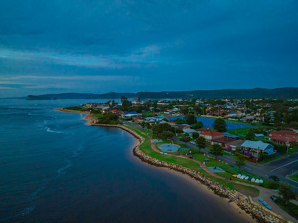 Aerial sunrise waterscape with boats, colour and clouds