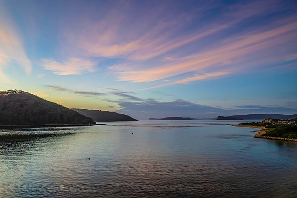 Aerial sunrise waterscape with boats