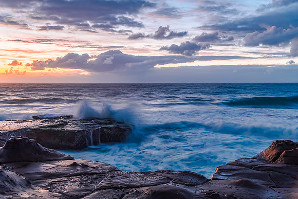 Sunrise, sea, waves, clouds and tessellated rock platform