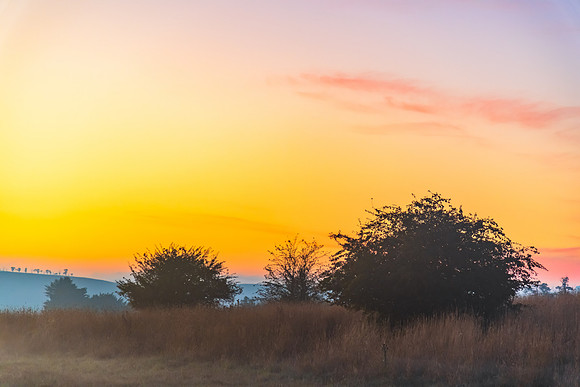 Sunrise over the countryside on the outskirts of country town wi