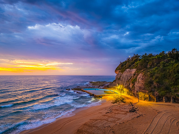 Pretty Sunrise at the seaside with rain clouds