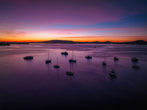 Dawn Colour Palette over the bay with boats and high cloud