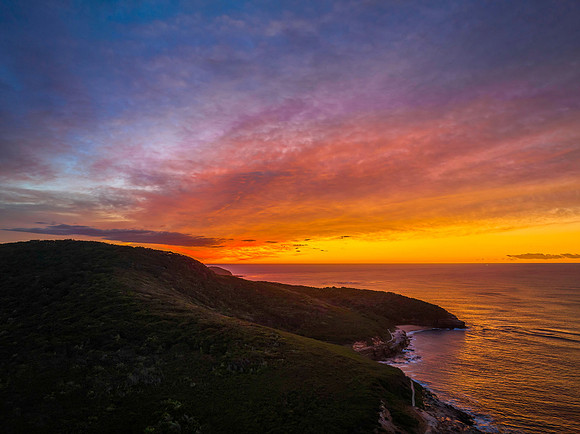 High cloud sunrise over the mountain and sea