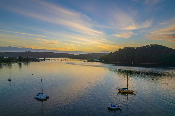 Aerial sunrise waterscape with boats