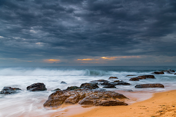 Sunrise at the seaside with rocks and beautiful diffused light b
