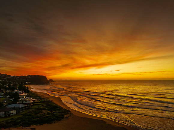 Sunrise and high cloud cover by the sea and lagoon