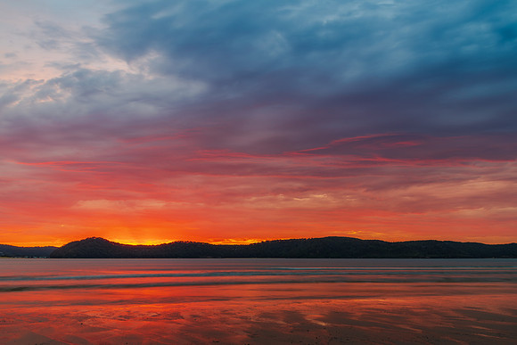Colourful cloud filled sunrise at the seaside