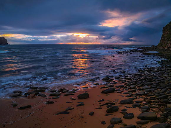 Moody sunrise seascape with rain clouds
