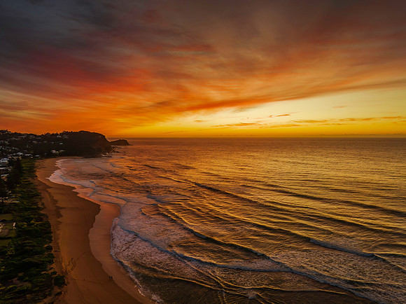 Sunrise and high cloud cover by the sea and lagoon