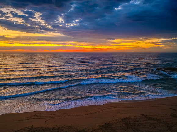 Pretty Sunrise at the seaside with rain clouds