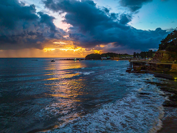 Aerial sunrise at the seaside with rain clouds