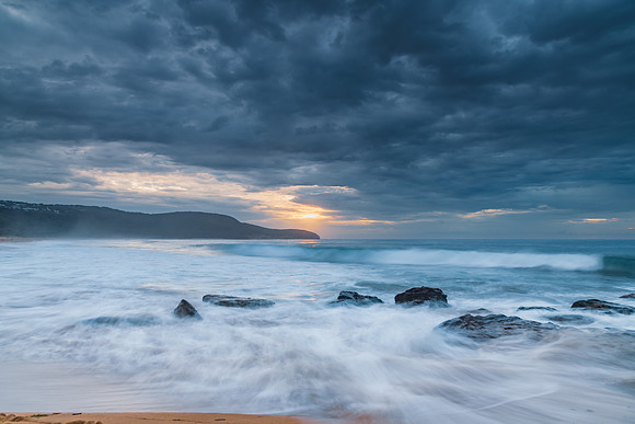 Sunrise at the seaside with rocks and beautiful diffused light b