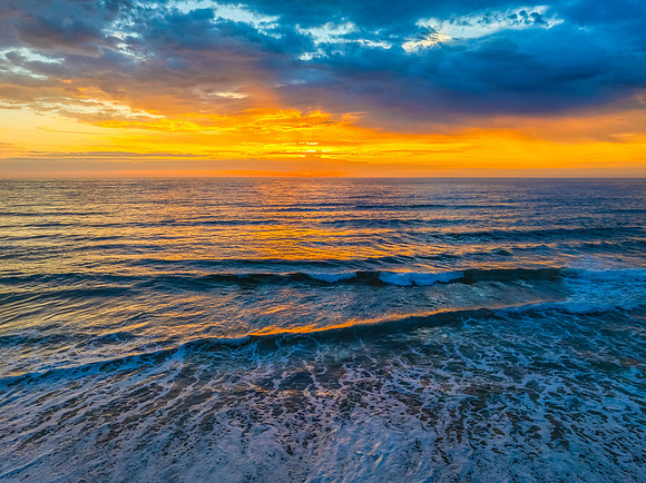 Pretty Sunrise at the seaside with rain clouds