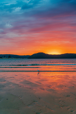 Colourful cloud filled sunrise at the seaside