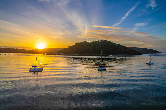 Aerial sunrise waterscape with boats