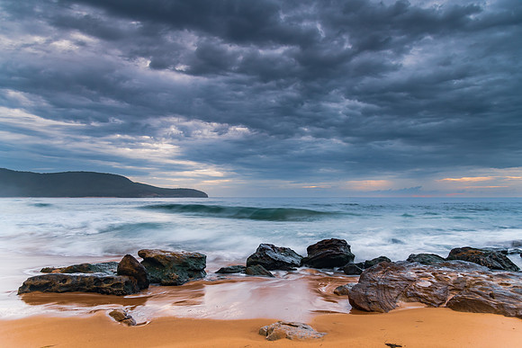 Sunrise at the seaside with rocks and beautiful diffused light b