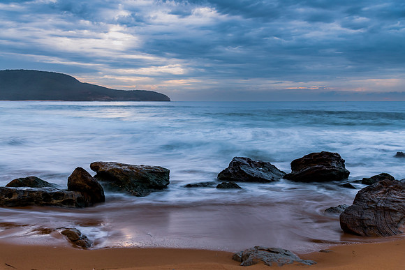 Sunrise at the seaside with rocks and beautiful diffused light b