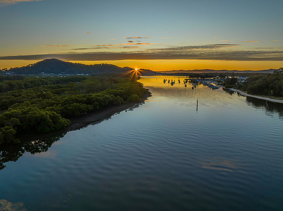 High cloud sunrise over the bay water