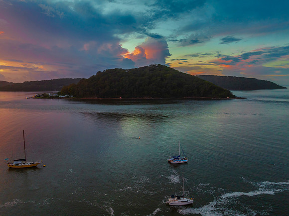 Aerial sunrise waterscape with boats, colour and clouds