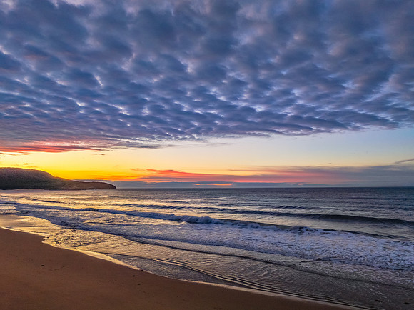 Winter seascape views over the beach with high and medium cloud