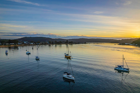 Aerial sunrise waterscape with boats