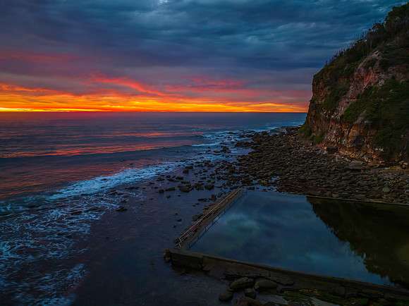 Cloud filled sunrise seascape with sea pool