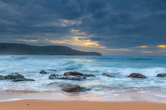 Sunrise at the seaside with rocks and beautiful diffused light b