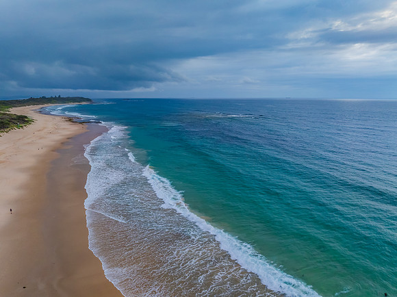 Sunrise Seascape with beautiful cloud covered sky and gentle sur