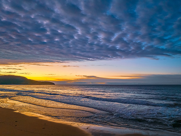 Winter seascape views over the beach with high and medium cloud