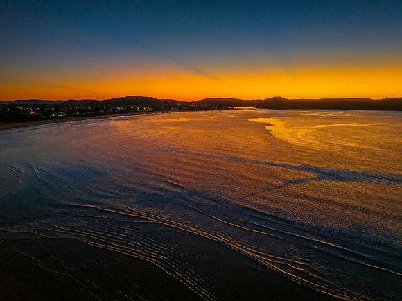 Aerial sunrise seascape with orange glow on a cold Winter's morn