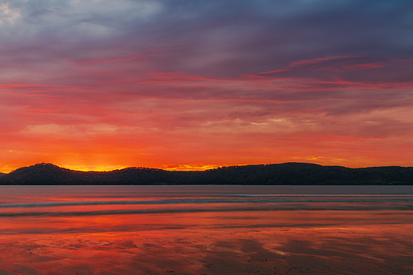 Colourful cloud filled sunrise at the seaside