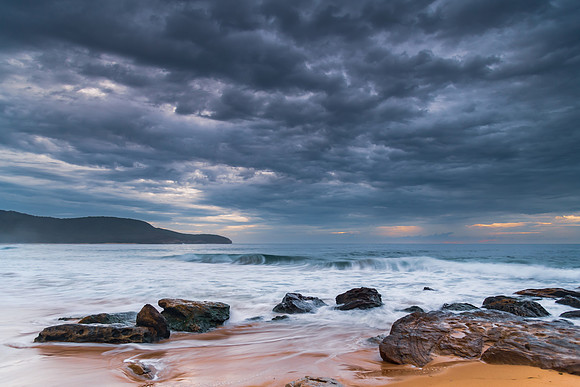 Sunrise at the seaside with rocks and beautiful diffused light b