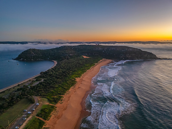 Sunrise over the sea with a low cloud bank and fog