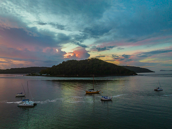 Aerial sunrise waterscape with boats, colour and clouds