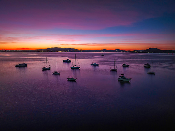 Dawn Colour Palette over the bay with boats and high cloud