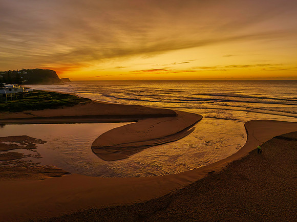 Sunrise and high cloud cover by the sea and lagoon
