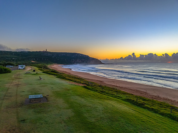 Sunrise over the sea with a low cloud bank and fog