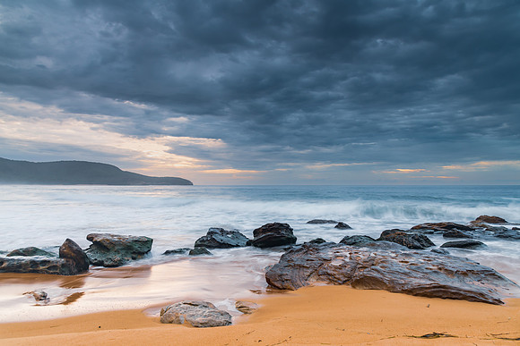 Sunrise at the seaside with rocks and beautiful diffused light b