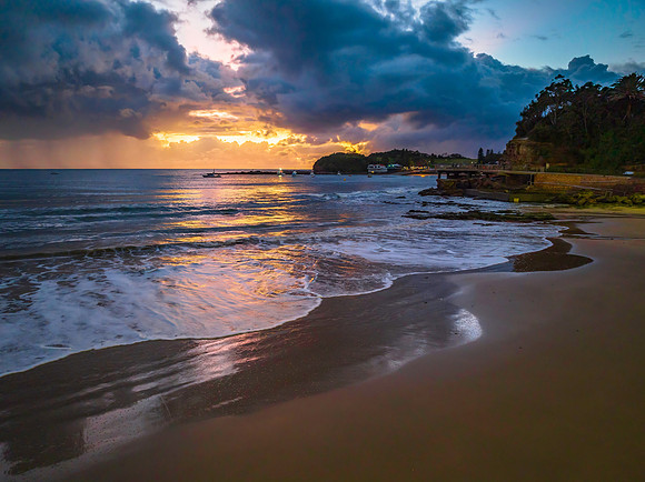 Aerial sunrise at the seaside with rain clouds