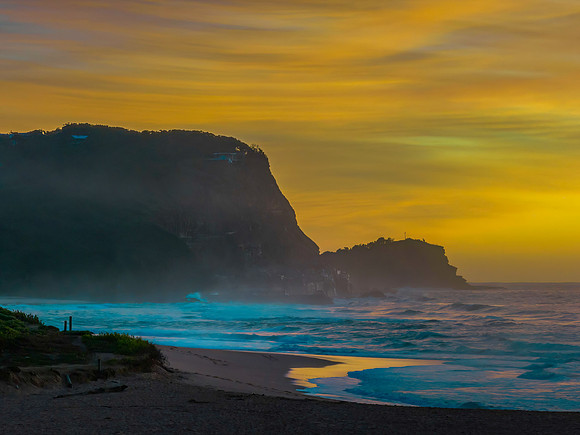 Sunrise and high cloud cover by the sea and headland