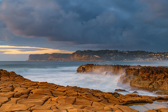 Sunrise, sea, waves, clouds and tessellated rock platform
