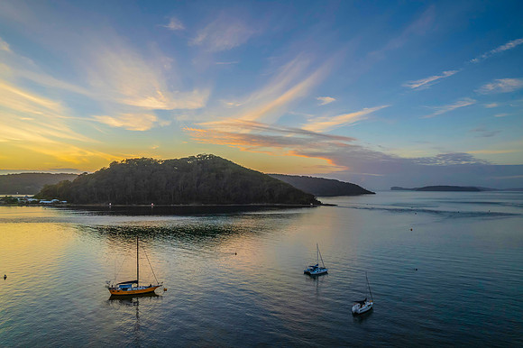 Aerial sunrise waterscape with boats