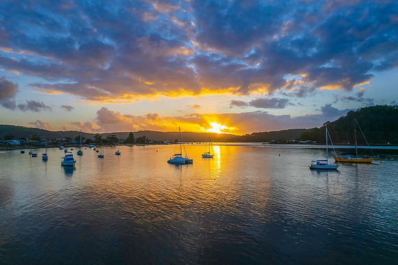 Aerial sunrise waterscape with boats